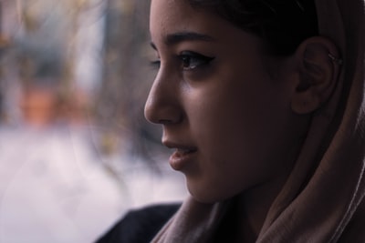 A woman dressed in brown hoodie overlooking
